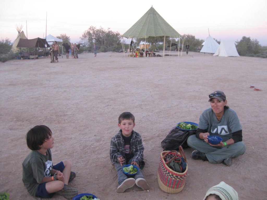 Dinner scene. In the background to the left you can see Alan's "knife shop': a tarp slung jauntily over two tepee poles. I'ts next to Benjamin Pixie's Meade, Honey, and essential oil stand.