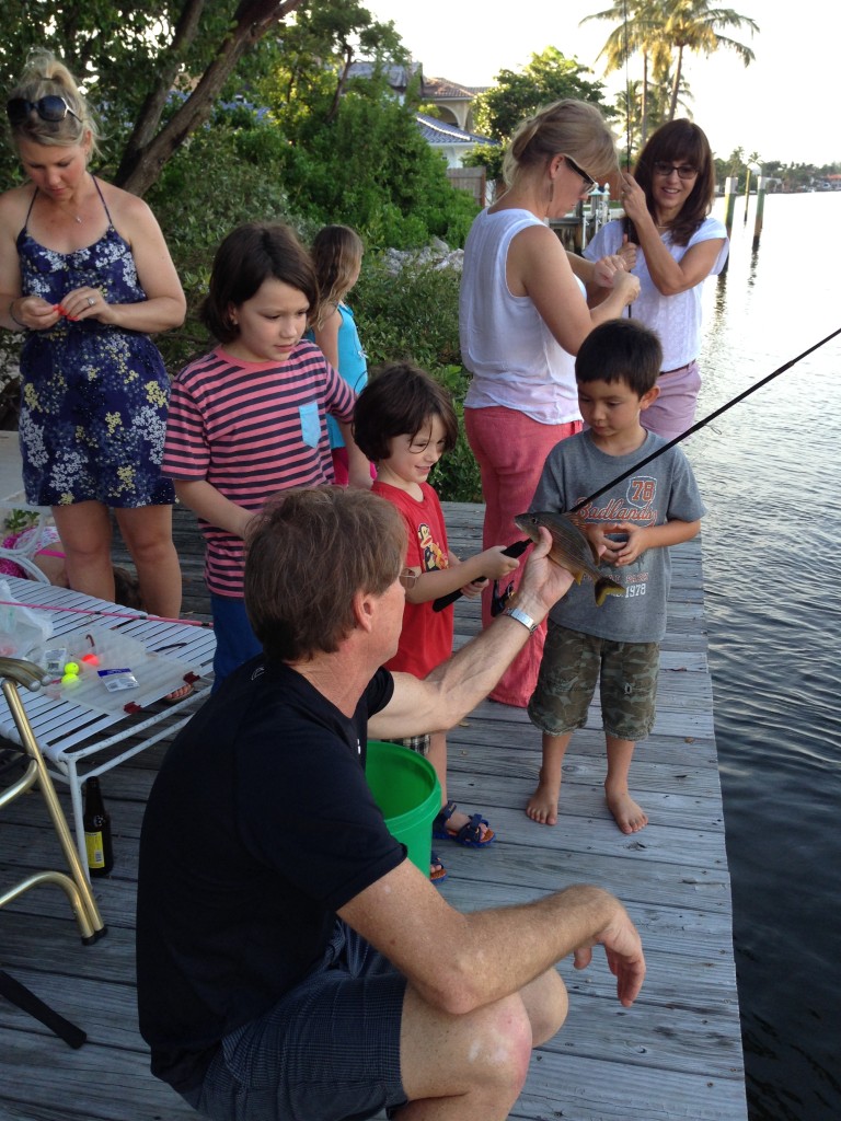 Fishing off the sea wall (another neighbor's backyard - across the street from Adam Sandler's vacation home!). C caught a mangrove snapper