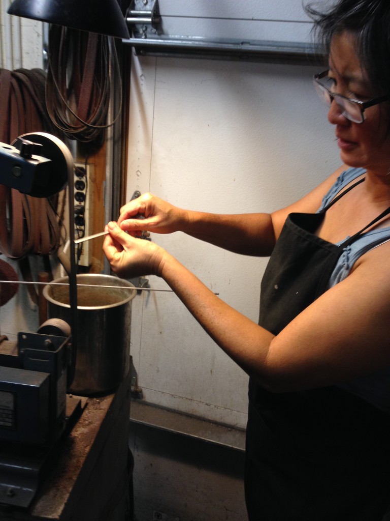 Polishing our steel bracelets that we made in Joe's metal shop with Joe's instruction.